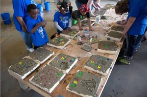 Ny’Asia and Na’Zir (grandchildren of Wanda Behneke) and Cash (grandson of Steve Beckman) work on concrete stepping stones.
